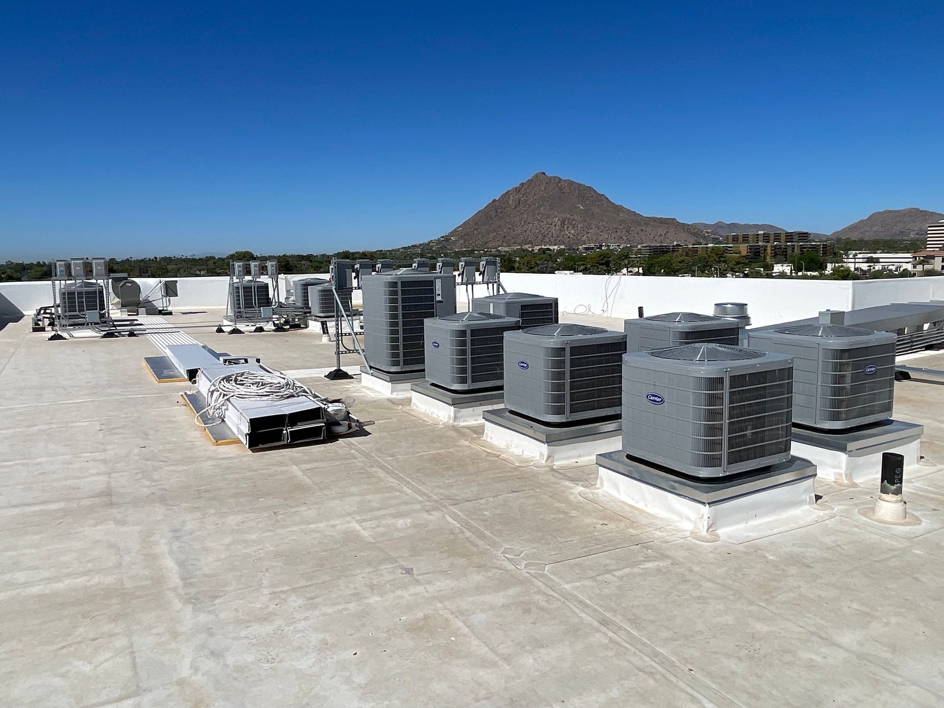 Rooftop AC installation with mountain view